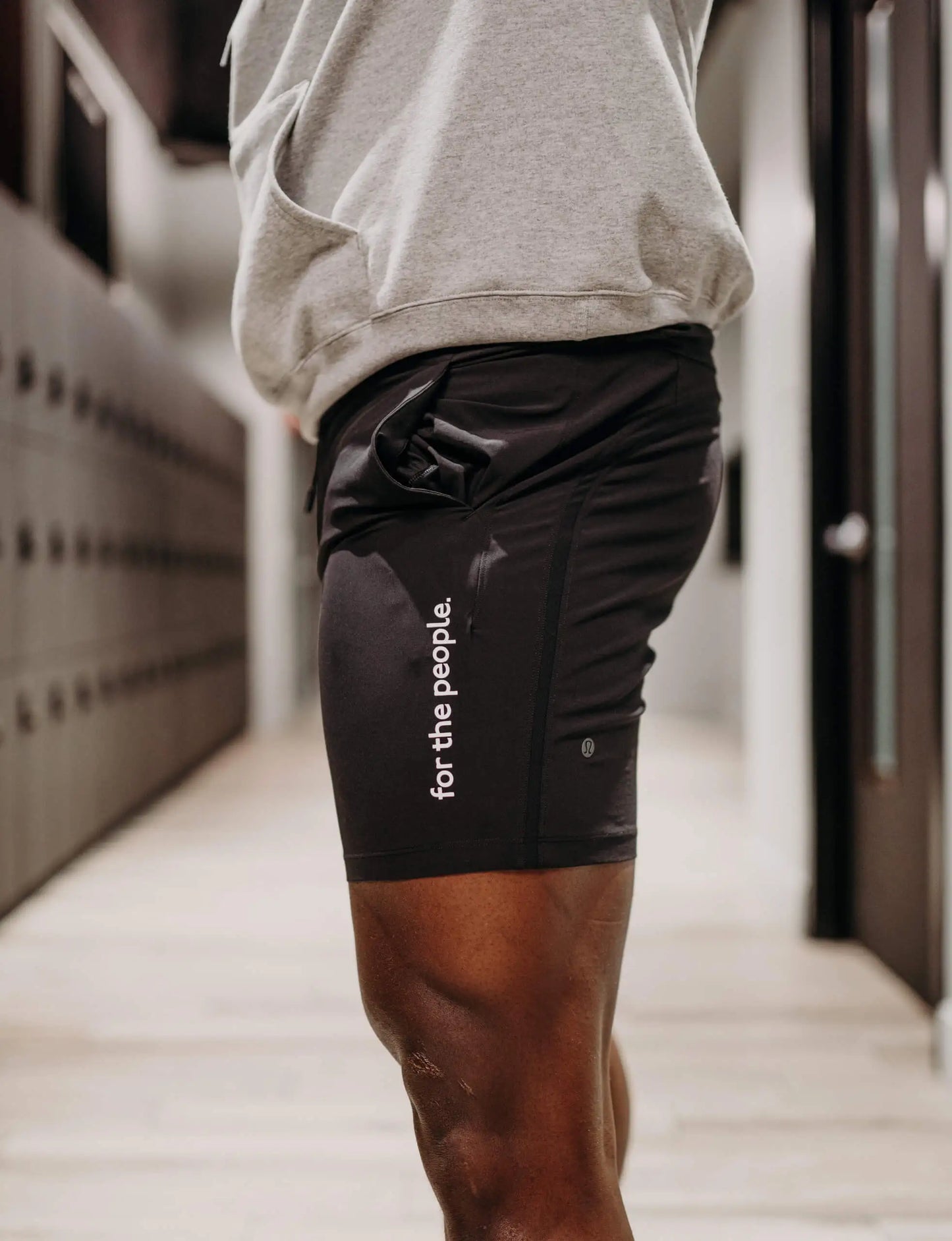 Lululemon Pace Breaker Linerless Short in Black with "for the people" printed vertically on left leg